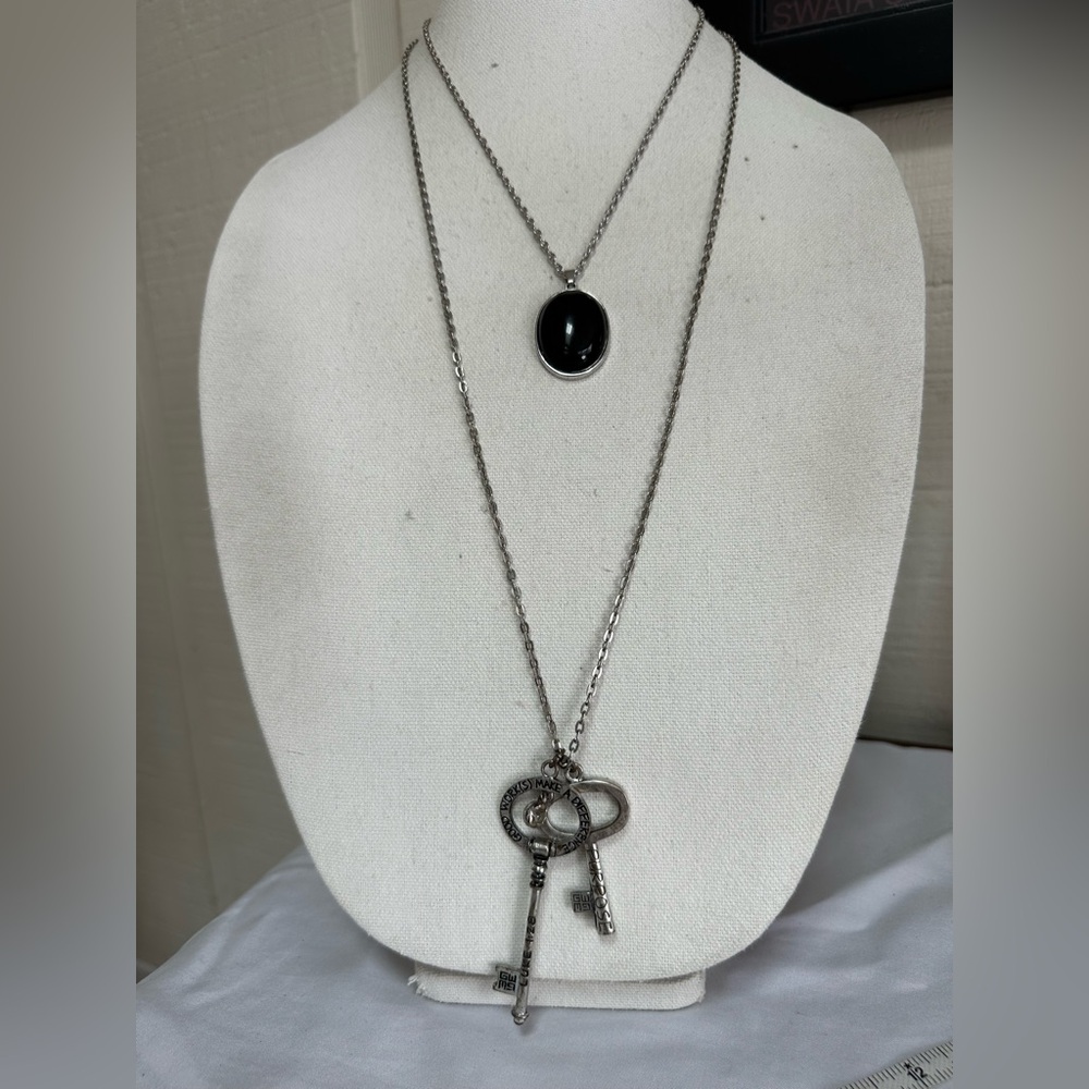 Two silvertone statement necklaces with keys and pendant